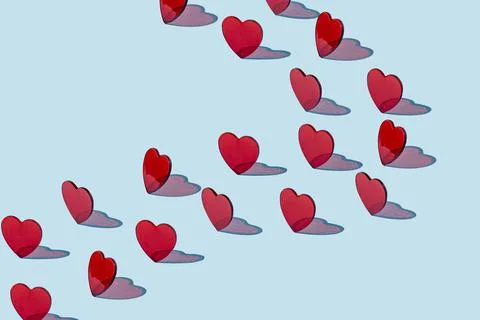 Creative pattern of red hearts on a blue background. Stock Photos