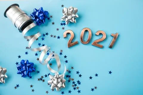 Creative pattern with shiny bow from bright ribbon on blue background. Trendy Stock Photos