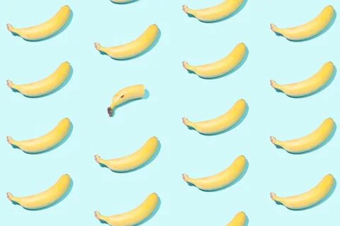 Creative pattern of whole bananas and one half of a banana - a concept on the Stock Photos