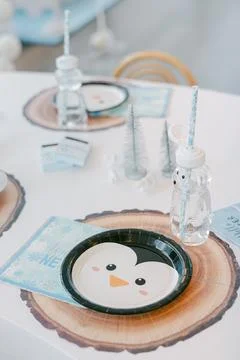Creative penguin-themed table setting for a childrens winter party celebration Stock Photos