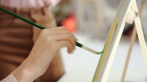 Creative pensive painter paints a colorful picture. Creative process of creating Stock Footage 72852897
