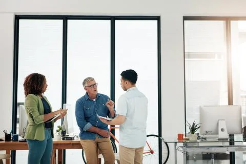 Creative, people and talking in office with advice, planning or graphic des.. Stock Photos
