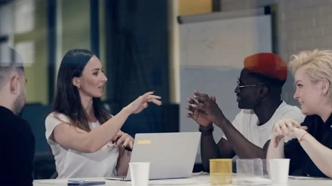 Creative people of different races are discussing a new business plan. Team Stock Footage 140918665