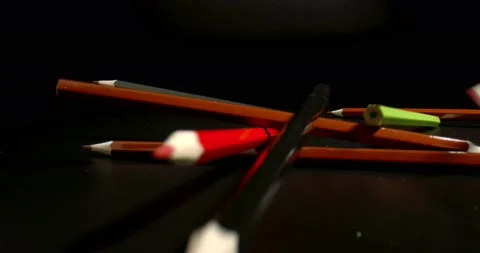 Creative people uniting concept. Falling multicolored pencils on black glossy Stock Footage 146648743
