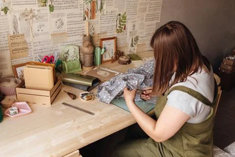 A creative person makes a scrapbook or notebook in their office. Handmade Stock Photos