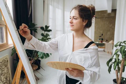 Creative person using brush and color palette for drawing Stock Photos