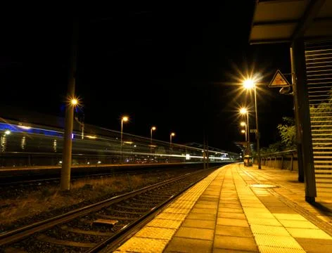 Creative perspective on a railstation in the night Foto stock