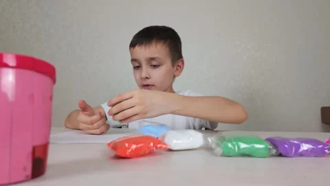 Creative Play A Child Enthusiastically Engaging with Various Colorful Craft Stock Footage 301693064