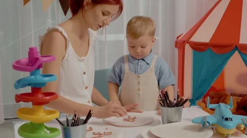 Creative playtime as a little boy enjoys crafting with crayon chips Stock Footage 329227748