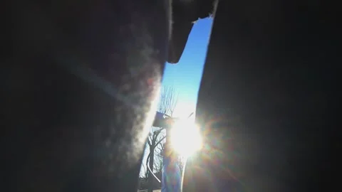 Creative POV through legs of kid riding bike towards sun Видео 280883737