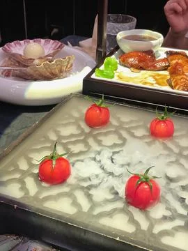 Creative presentation of fresh tomatoes on a unique dining setup in an upsc.. Stock Photos