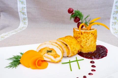 Creative presentation of a gourmet dish featuring chicken roulade with herbs Stock Photos