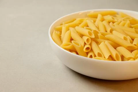 Creative presentation of penne pasta ready for culinary exploration at home Stock Photos