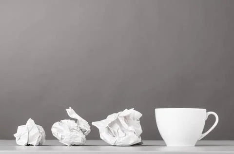 Creative process creative process. crumpled wads and cup on gray Copyright... 库存照片