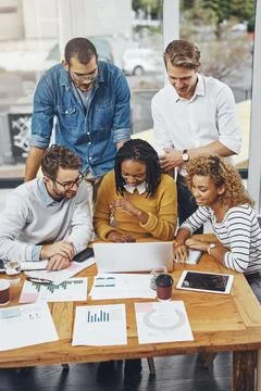 The creative process. High angle shot of a group of businesspeople looking at 写真素材