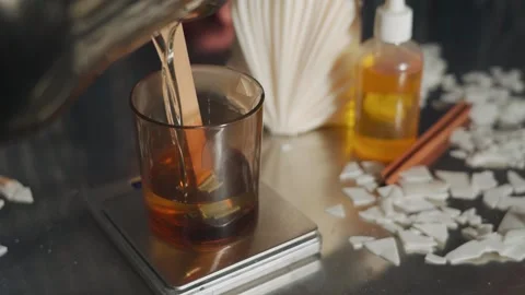 The creative process of making aromatic wax candles. A woman puts a wooden wick Vidéo 269494653