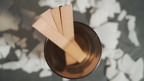 The creative process of making wax scented candles. There is a glass with wooden Vídeos de archivo 269405253