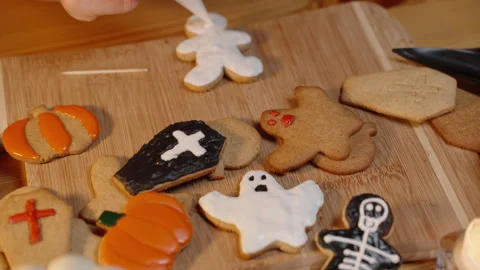 The Creative Process of Preparing for Halloween. A Woman Decorates Gingerbread Stock Footage 279006154