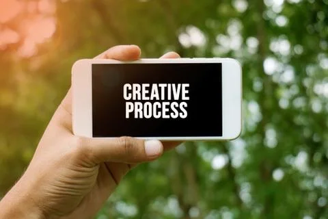 CREATIVE PROCESS word on smartphone with bokeh in background Stock Photos