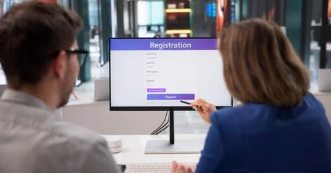 Creative Professionals Collaborate While Completing Online Sign-Up Forms On D Stock Photos