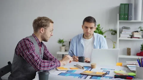 Creative professionals discussing ideas in office Stock Footage 142519488