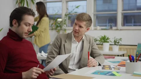 Creative professionals discussing project design Stock Footage 142144829