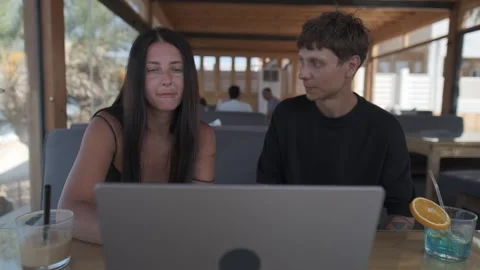 Creative professionals reviewing project together on laptop, discussing details 스톡 동영상 346242580