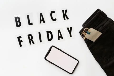Creative promotion composition Black friday text and jeans on white backgroun Stock Photos