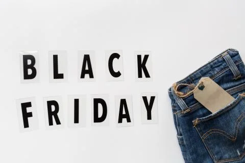 Creative promotion composition Black friday text and jeans on white backgroun Stock Photos