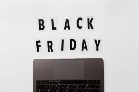 Creative promotion composition Black friday text and laptop on white backgrou Stock Photos