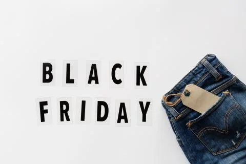 Creative promotion composition Black friday text and jeans on white backgroun Stock-Fotos