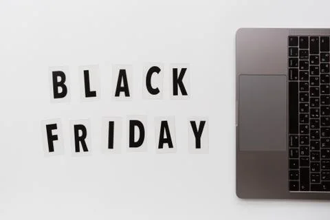 Creative promotion composition Black friday text and laptop on white backgrou Stock Photos
