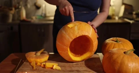 The Creative Pumpkin Carving Process Takes Place in a Cozy and Inviting Kitchen Stock Footage 285918109
