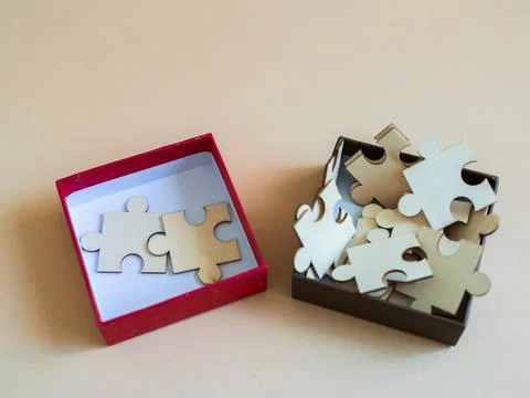 Creative puzzle pieces in open boxes on simple background for art and desig.. Stock Photos