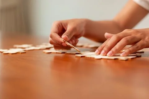 Creative puzzle solving activity at home cozy environment close-up view fun.. 스톡 사진