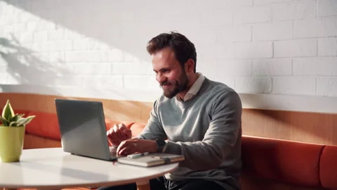 Creative, remote work and businessman with laptop in cafe, typing or email 動画素材 336198628