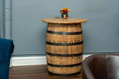 Creative restaurant table made from a repurposed barrel, unique furniture Stock Photos