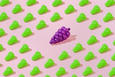 Creative salad and grape pattern flat lay on pastel pink background minimalis Stock Photos