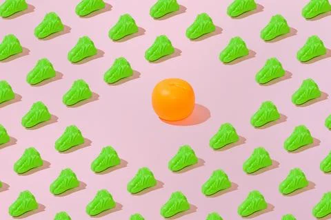 Creative salad and orange pattern flat lay on pastel pink background minimali Stock Photos