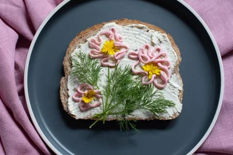 Creative sandwich with soft cheese and pink pasta tarama greens, flowers Stock Photos