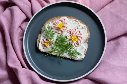Creative sandwich with soft cheese and pink pasta tarama greens, flowers Stock Photos