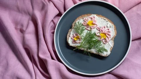 Creative sandwich with soft cheese and pink pasta tarama greens, flowers Stock Photos