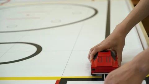 Creative schoolboy demonstrates how to ride his handmade red cardboard car on Видео 108440322