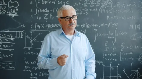Creative scientist raising finger having good idea working with chalkboard in Stock Footage 124937995