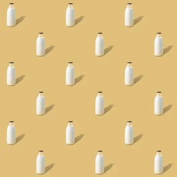 Creative seamless pattern with bottle of vegan milk on a yellow background Stock Photos