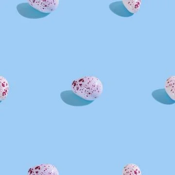 Creative seamless pattern with easter quail eggs on light blue background. Ab 스톡 사진