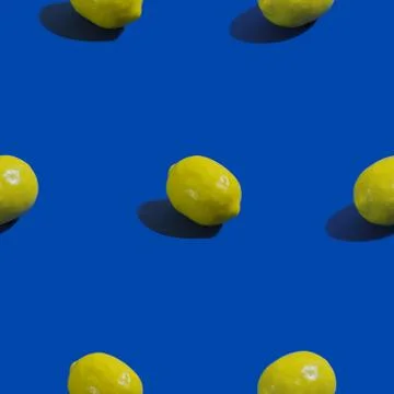 Creative seamless pattern with lemon on blue background. Tropical abstract ba Stock Photos