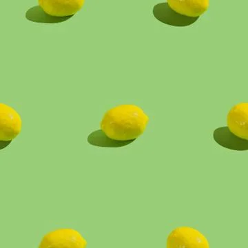 Creative seamless pattern with lemon on green background. Tropical abstract b Stock Photos