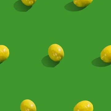 Creative seamless pattern with lemon on green background. Tropical abstract b Stock Photos