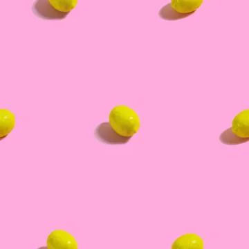 Creative seamless pattern with lemon on pink background. Tropical abstract ba Stock Photos